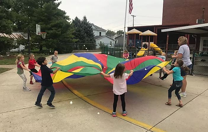 Students playing with parachute
